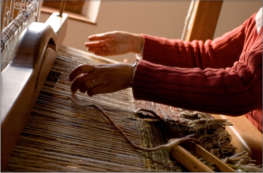 Person working on the loom.